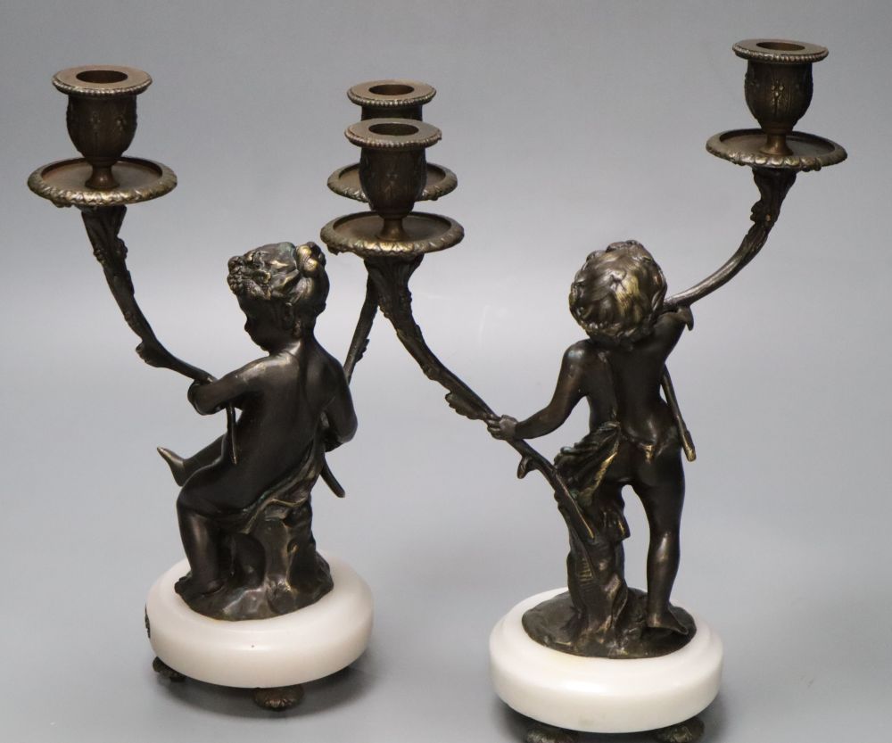 A pair of bronzed-finished metal figural candelabra, on circular bases, height 31cm